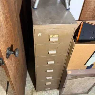 Sale Photo Thumbnail #394: Vintage tan industrial metal multi-drawer file cabinet alongside a dusty Oasis dehumidifier.