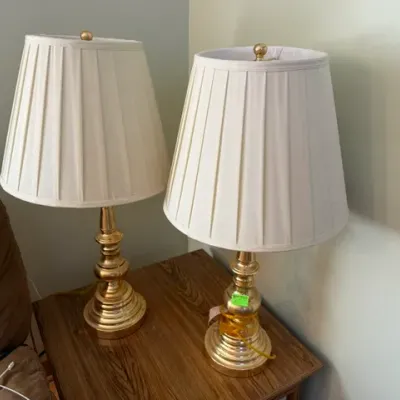 Sale Photo Thumbnail #46: Pair of vintage polished brass table lamps featuring turned baluster stems and pleated cream fabric lampshades.