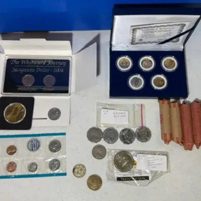 Sale Photo Thumbnail #60: Collection of US and international commemorative coin sets, loose coins, and rolled pennies.