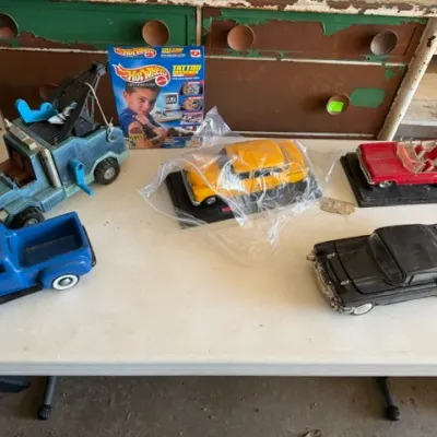 Sale Photo Thumbnail #464: Collection of vintage toy and model cars, including a blue pickup truck, tow truck, die-cast models, and a Hot Wheels Tattoo Designer box set.