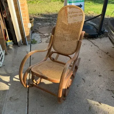 Sale Photo Thumbnail #462: Vintage Thonet-style bentwood rocking chair featuring woven cane backrest and seat panels.