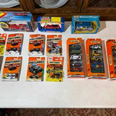 Sale Photo Thumbnail #74: Collection of Matchbox toy vehicles in original packaging, including boxed Super Kings models and blister-pack single and multi-vehicle sets.
