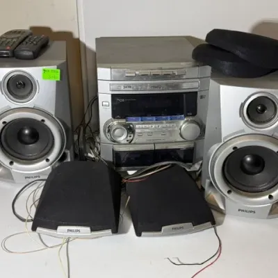 Sale Photo Thumbnail #333: Vintage Philips silver mini stereo system with 3-CD changer, dual cassette decks, main speakers, surround sound speakers, and two remotes.