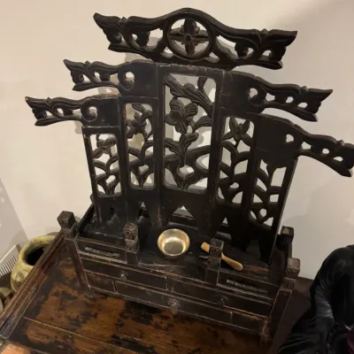 Sale Photo Thumbnail #29: Carved dark wood Asian altar cabinet or dressing stand featuring ornate pierced fretwork, small drawers, and a small brass singing bowl with striker.