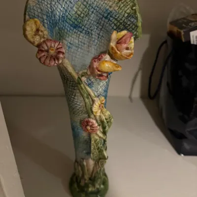 Sale Photo Thumbnail #47: Handmade studio pottery vase featuring applied floral accents, a textured basketweave pattern, and colorful glazes.