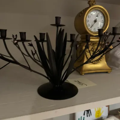 Sale Photo Thumbnail #46: Black wrought iron multi-light floral candelabra displayed next to an ornate gold mantle clock on a shelf.