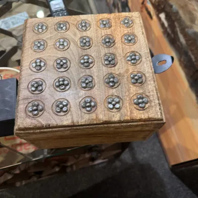 Sale Photo Thumbnail #3: Square wooden trinket box with flower-shaped metal studs inlaid on the lid and a side latch.