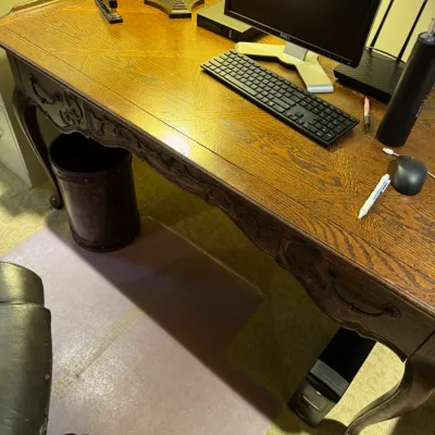 Sale Photo Thumbnail #75: French Provincial style carved oak writing desk featuring a parquet wood top and cabriole legs, paired with computer accessories.
