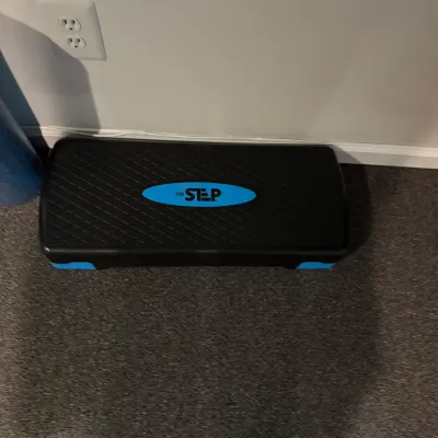 Sale Photo Thumbnail #48: The Step brand aerobic fitness bench in black with blue trim accents.