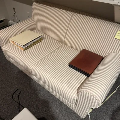 Sale Photo Thumbnail #39: Two-seat loveseat upholstered in a beige and white ticking stripe fabric, styled with rolled arms and matching piping detail.