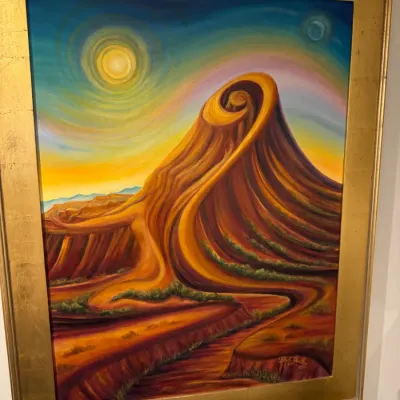 Sale Photo Thumbnail #25: Framed surrealist landscape oil painting featuring stylized desert rock formations and celestial elements, housed in a wide gilt wood frame.