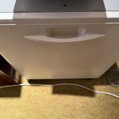 Sale Photo Thumbnail #74: Modern white home or office paper shredder, showing front cabinet drawer and top control interface.