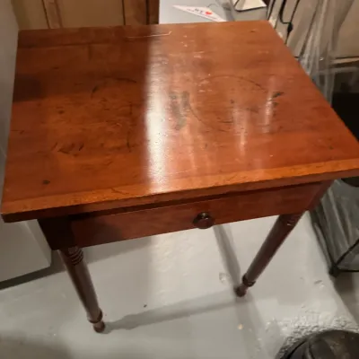 Sale Photo Thumbnail #61: Vintage cherry finish wooden side table featuring a single drawer with a round wooden knob and turned legs.