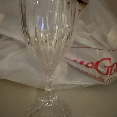 Sale Photo Thumbnail #19: Single cut crystal wine glass with a vertical fluted pattern and a textured pedestal base.