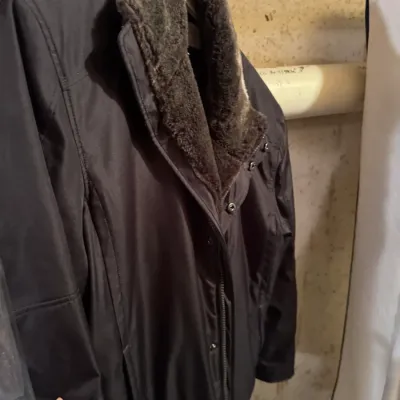 Sale Photo Thumbnail #63: Black nylon zip-front winter jacket with faux fur lining along the collar and inner lapel.