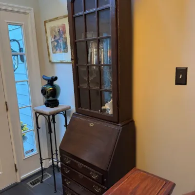 Sale Photo Thumbnail #20: Traditional dark wood secretary desk with glass-front hutch and slant-front writing surface.