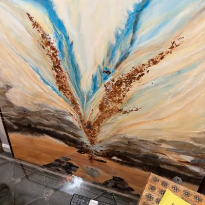 Sale Photo Thumbnail #56: Large abstract canvas painting featuring sweeping blue, cream, and textured copper-colored tones in a thin dark frame.