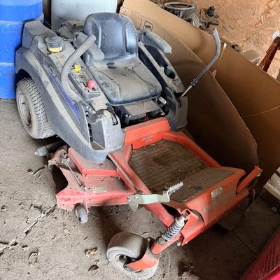 Simplicity Javelin zero-turn riding lawn mower showing heavy dust and wear from garage storage.