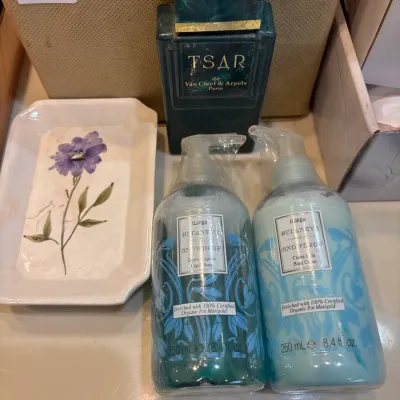 Collection of bath and vanity items including a bottle of Tsar de Van Cleef & Arpels cologne, a pair of ElAria Snowdrop hand soap and...