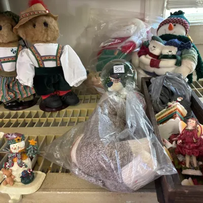 Collection of holiday decorations and collectibles, including Boyds Bears in traditional German attire, plush snowmen, small angel...