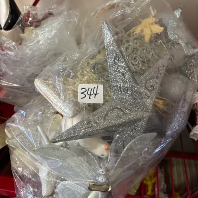 Bagged collection of silver and white Christmas decorations, featuring glittery stars, beaded accents, and clip-on butterfly ornaments.