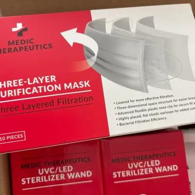 Box of Medic Therapeutics three-layer purification masks, containing 10 pieces, stacked with other wellness products.