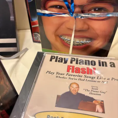 "Play Piano in a Flash!" audio CD featuring Scott Houston, along with wrapped books and other media.