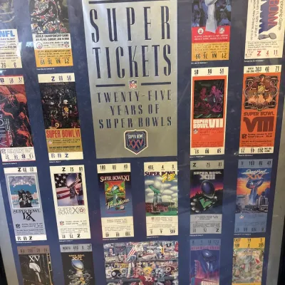 Framed Seagram's Coolers Super Tickets poster, celebrating twenty-five years of Super Bowl ticket designs through Super Bowl XXV in...