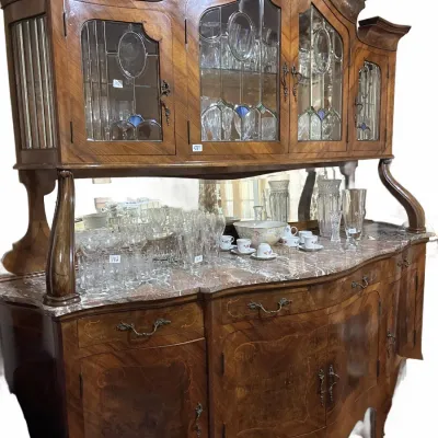 Antique Rococo Revival style walnut buffet hutch featuring intricate marquetry inlays, a marble top surface, leaded glass cabinet doors,...