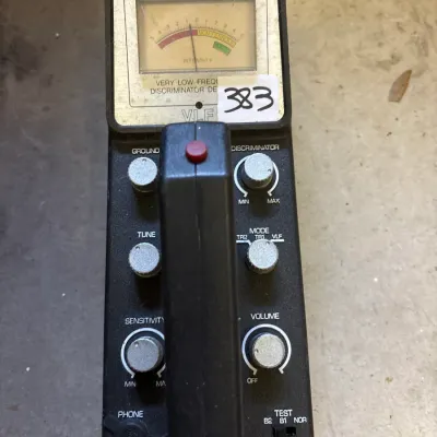 Vintage Radio Shack VLF metal detector control box, featuring an analog meter and silver adjustment knobs.
