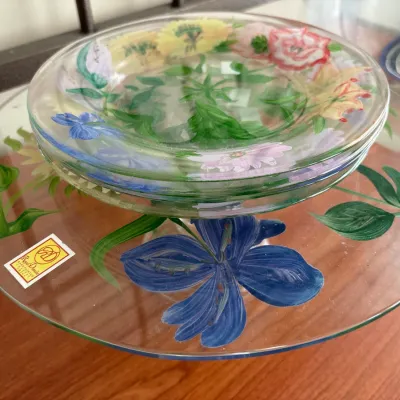 Hand-painted glass cake stand by Royal Danube featuring vibrant floral motifs, topped with matching glass plates.