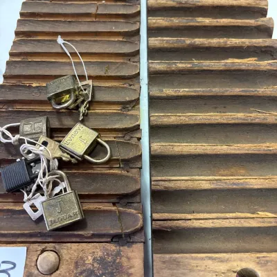Vintage wooden cigar mold press halves displaying distressed, weathered surfaces, paired with a small collection of vintage miniature...