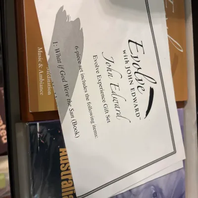 Evolve with John Edward six-piece gift set, including books and media items inside its original box.