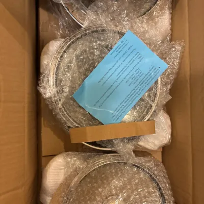 New-in-box Cuisine-Cookware 7-piece triple burner buffet set, packed in original bubble wrap with documentation.