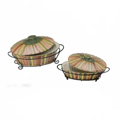 Pair of striped ceramic covered casserole dishes with black wrought iron metal stands.