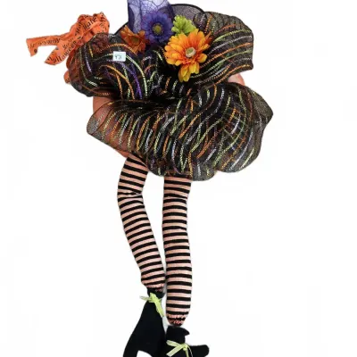 Whimsical Halloween witch-themed wreath featuring a purple pointy hat, colorful mesh ruffles, faux flowers, and dangling striped legs...