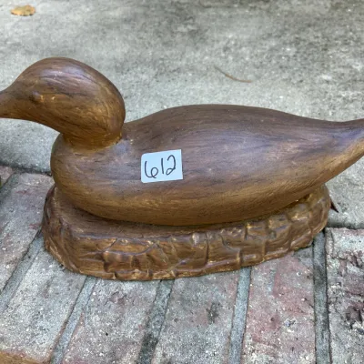 Hand-painted duck decoy figurine mounted on an integral textured base, featuring a woodgrain finish.