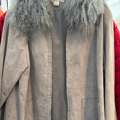 Isa International light blue suede zip-up jacket featuring a voluminous curly shearling collar and front patch pockets.