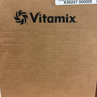 Vitamix blender boxed in original cardboard shipping container with barcode label.