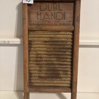 Vintage Dubl Handi washboard with a wooden frame and corrugated metal surface, manufactured by Columbus Washboard Co.