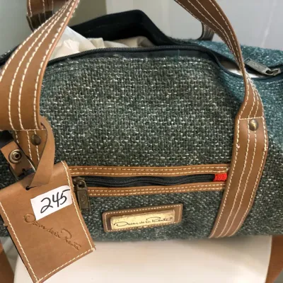 Oscar de la Renta tweed and tan leather duffle bag with contrast stitching and matching luggage tag.