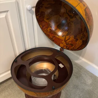 Vintage Italian-style floor globe bar cabinet featuring an old-world map exterior, zodiac illustrations inside the lid, and built-in...