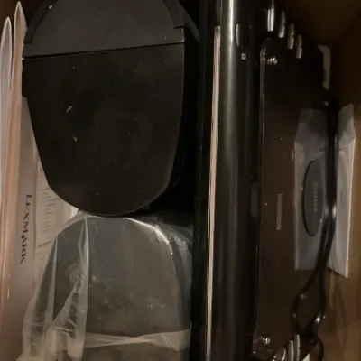 Black Sony shelf stereo system and speakers packed inside a cardboard box.