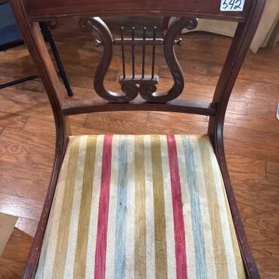 Vintage Duncan Phyfe style dining chair featuring a lyre back design and colorful striped upholstered seat.