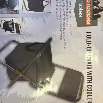 Outdoors by Totes fold-up chair featuring an integrated cooler compartment under the seat, presented in its original retail box.