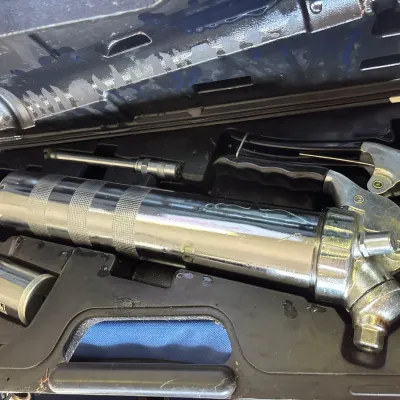 MVP Pro-Tech heavy-duty chrome grease gun kit, stored inside its original black molded plastic carrying case.