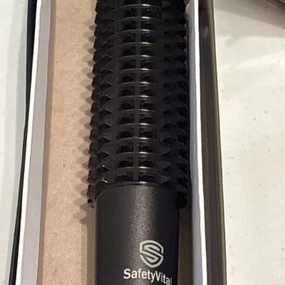 SafetyVital personal safety hair brush self-defense tool, presented unused in its original box.