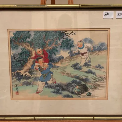 Framed Chinese watercolor print depicting children playing in a landscape, presented in a faux-bamboo metal frame with double matting.