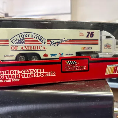 Racing Champions 1:64 scale die-cast Factory Stores of America #75 NASCAR racing team transporter, new in original packaging.