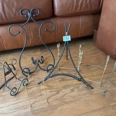 Assortment of metal tabletop display easels in various sizes, finishes, and scrolled designs.